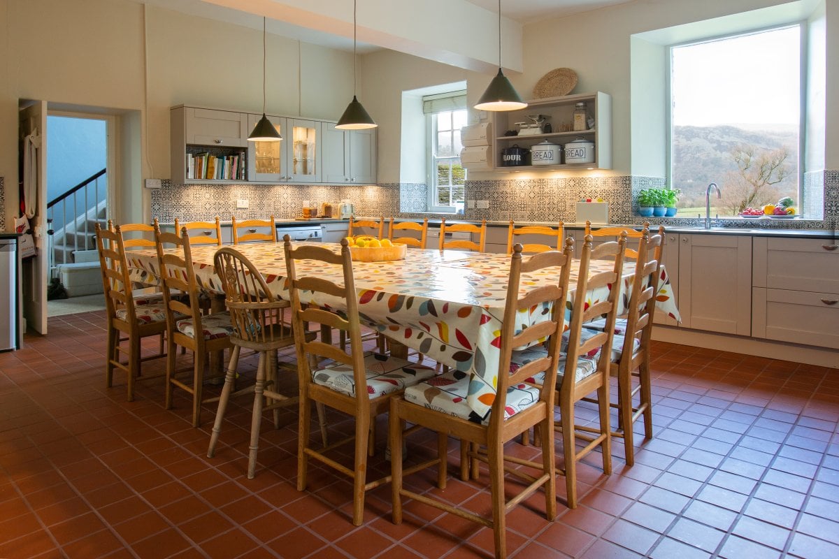 The kitchen table with seating for 16 people